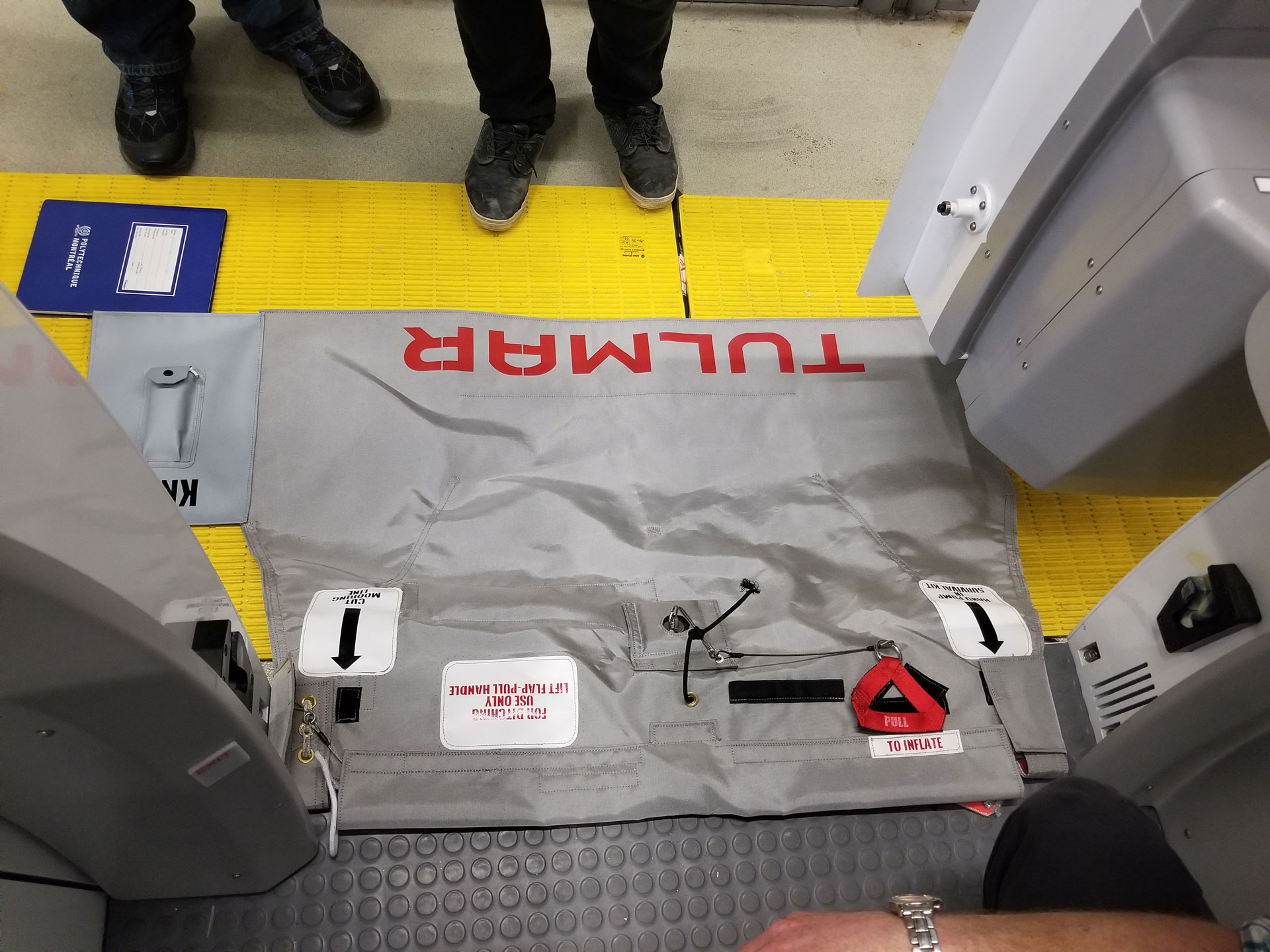 An overhead view of an girt trainer with instructions, surrounded by machinery.