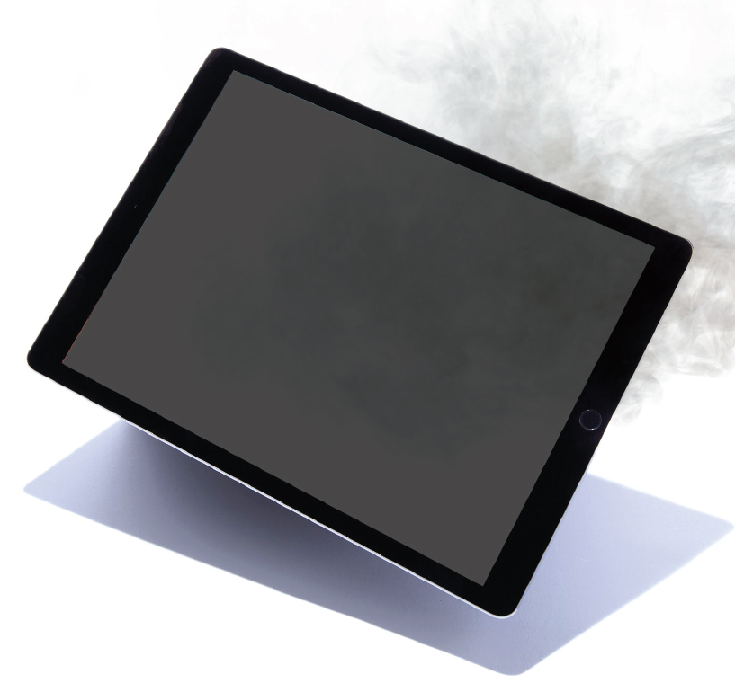 A tablet with a blank screen laying diagonally on a white surface, casting a shadow.